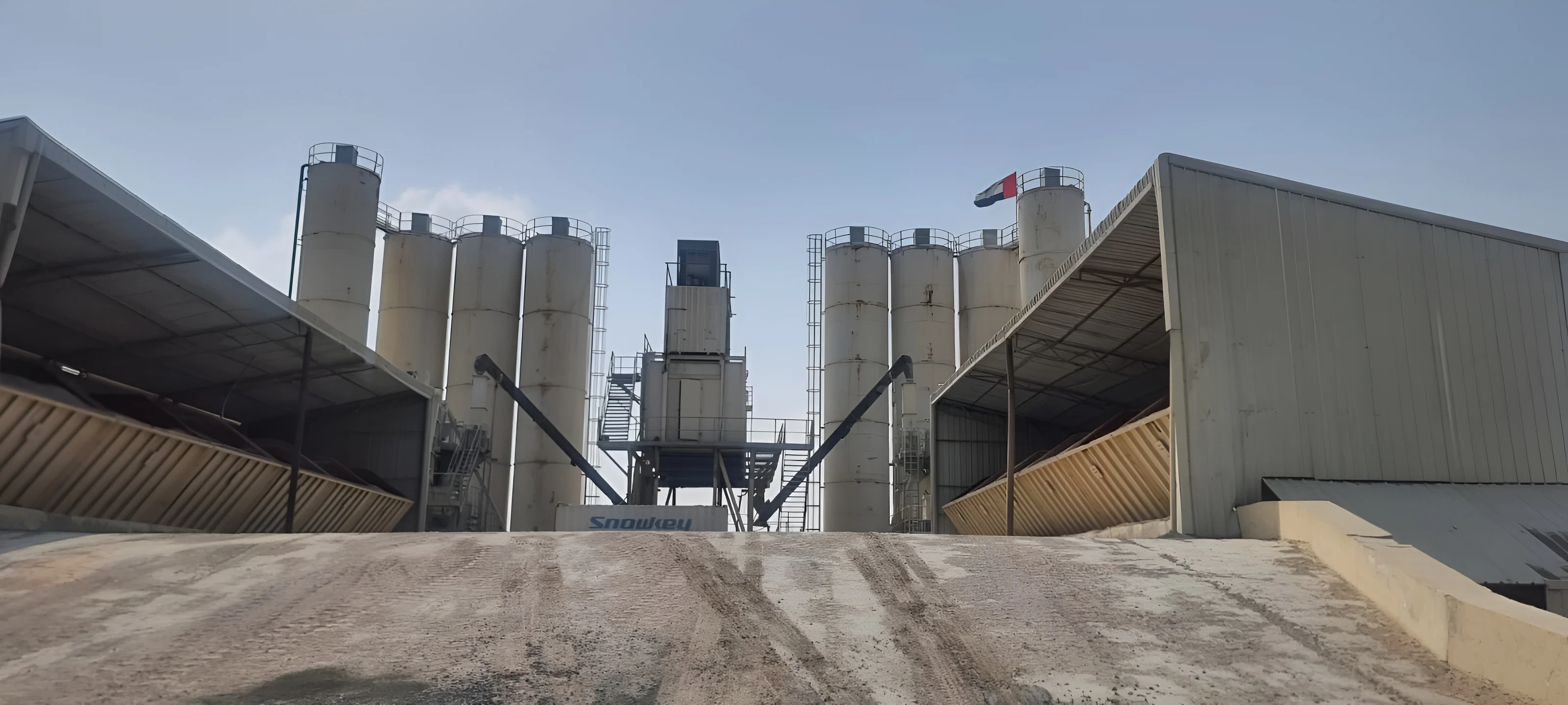 Wide-angle view of Solid Mix concrete batch plant with silos and aggregate sheds — Dubai